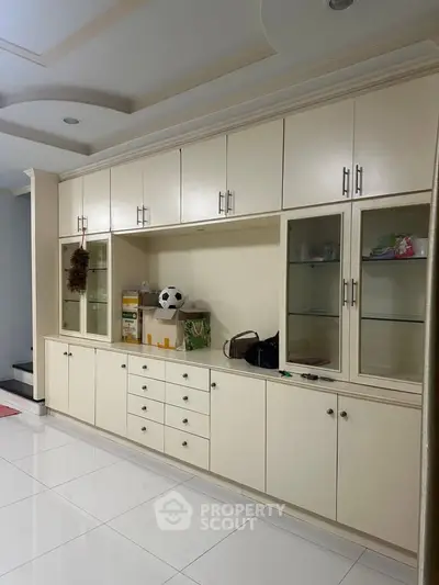 Spacious living room with built-in storage cabinets and modern decor