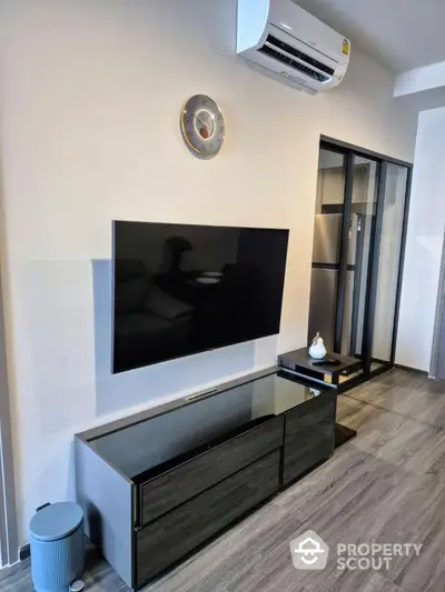 Modern living room with sleek TV setup and air conditioning