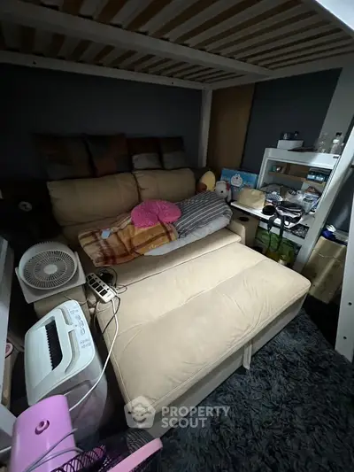 Cozy small living area with sofa bed and shelving in compact space