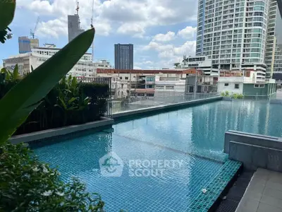 Luxurious rooftop pool with stunning cityscape views in modern urban setting.