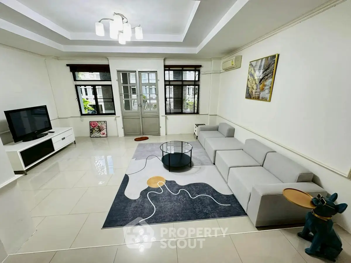 Spacious modern living room with stylish decor and ample natural light