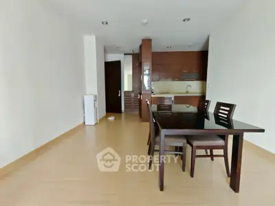 Spacious open-plan living and dining area with modern kitchen in a contemporary apartment.