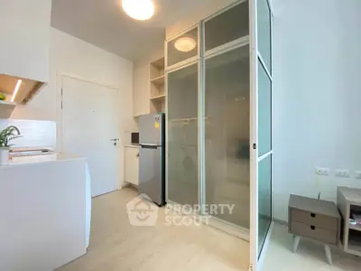 Modern kitchen with sleek appliances and ample storage in a stylish apartment.