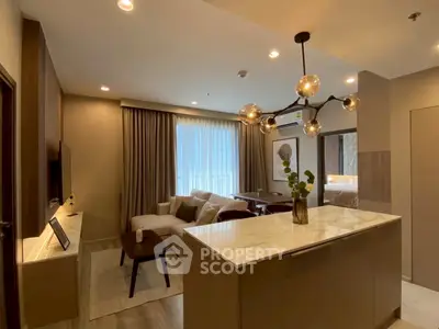 Modern living room with stylish lighting and open kitchen layout in a cozy apartment.