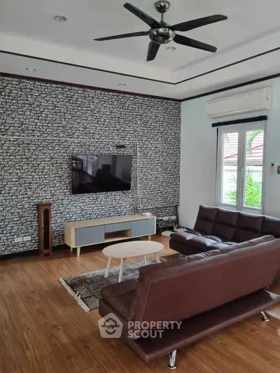 Stylish living room with modern furniture and stone accent wall
