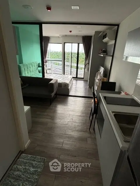 Modern studio apartment with open layout and balcony view