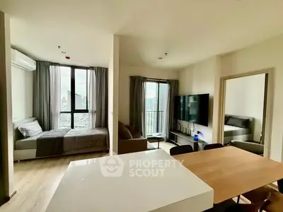 Modern open-plan living room with city view and stylish decor