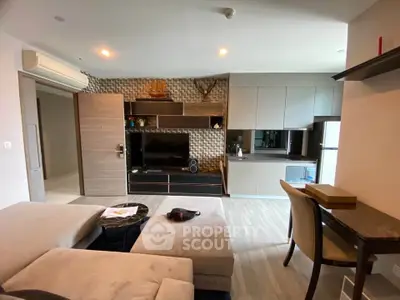 Modern living room with stylish furniture and open kitchen layout