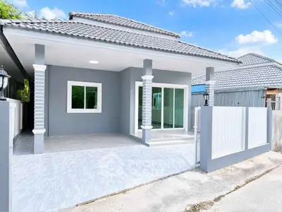 Charming modern house with tiled patio and sleek gray exterior, perfect for family living.