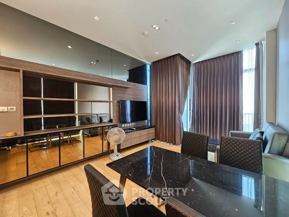 Luxurious modern living room with elegant dining area and floor-to-ceiling windows.