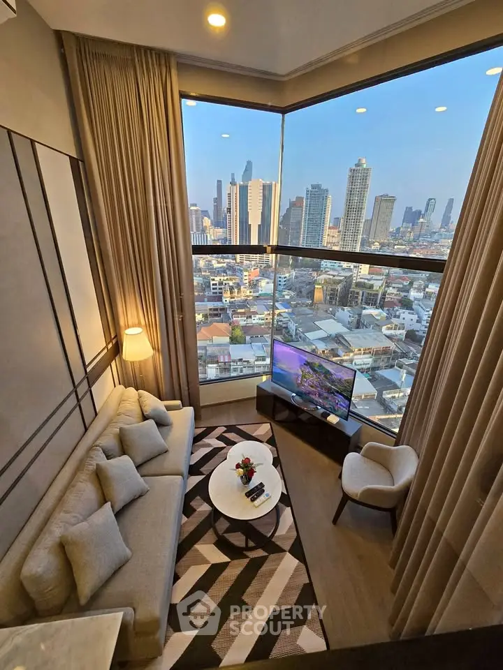 Luxurious high-rise living room with stunning cityscape view through floor-to-ceiling windows.