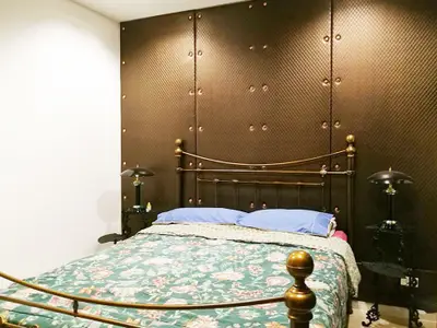 Luxurious bedroom with elegant metal bed frame and unique wall design