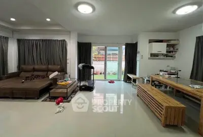 Spacious living room with modern decor and large windows for natural light.