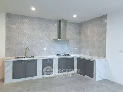 Modern kitchen with sleek cabinetry and gas stove in a stylish open layout