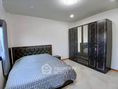 Spacious bedroom with modern furniture and ample natural light