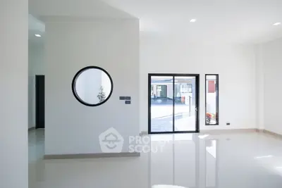 Modern minimalist interior with large windows and circular wall feature