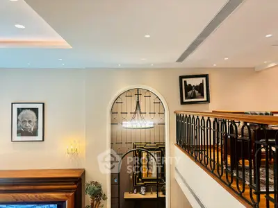 Elegant interior with stylish railing and artwork, showcasing a sophisticated living space.