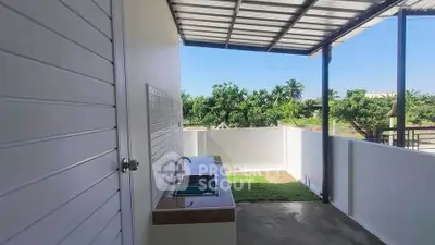Charming outdoor kitchen area with lush garden view and modern sink setup.