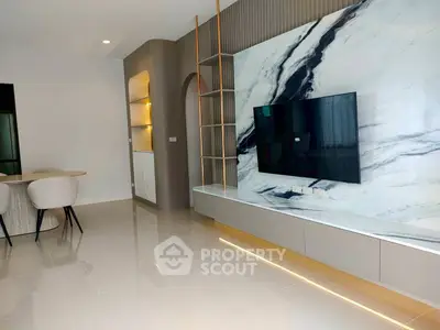 Modern living room with marble accent wall and sleek TV setup