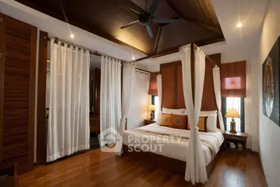 Luxurious bedroom with elegant wooden decor and canopy bed in a serene setting.