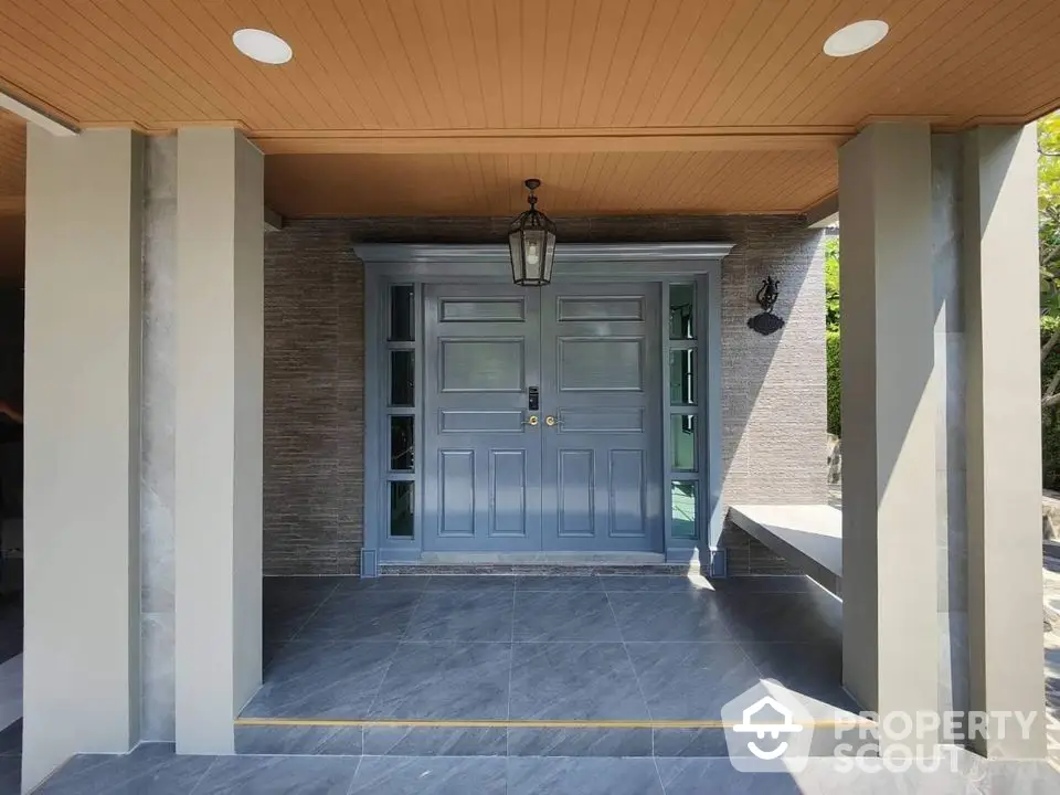 Elegant modern entrance with stylish double doors and sleek tile flooring