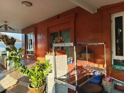 Charming balcony with brick walls and lush plants, perfect for relaxation.