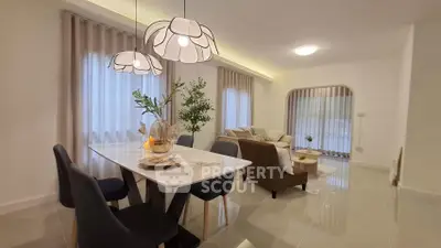 Elegant living room with modern dining area and stylish lighting, perfect for entertaining guests.