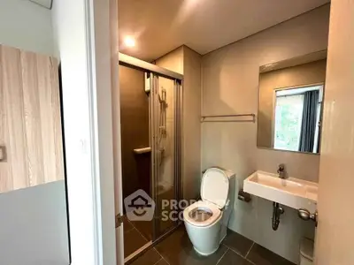 Modern bathroom with sleek shower and contemporary fixtures in a stylish apartment.