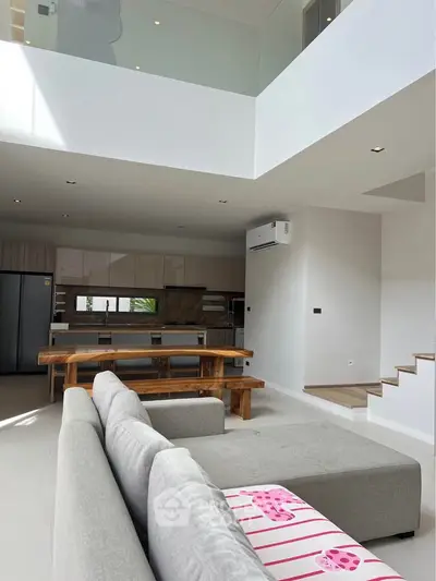 Spacious open-plan living room with modern kitchen and stylish decor