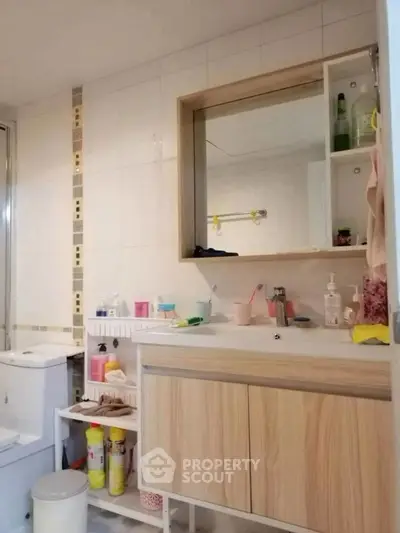 Modern bathroom with wooden vanity and ample storage space