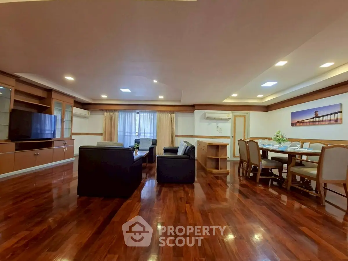 Spacious living room with elegant wooden flooring and modern furniture