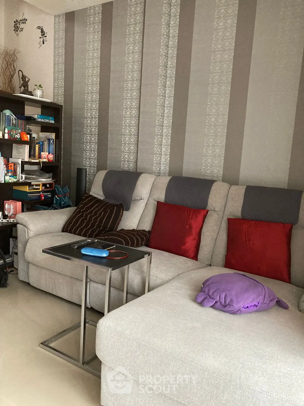Cozy living room with modern sectional sofa and decorative cushions, perfect for relaxation and entertainment.