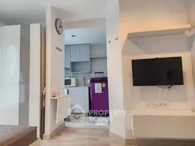 Modern apartment interior with kitchen and living area, featuring sleek design and contemporary appliances.