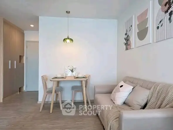 Chic modern living room with cozy sofa and stylish dining area in open layout apartment.