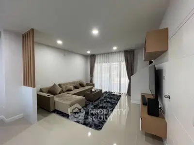 Modern living room with stylish furniture and large window drapes