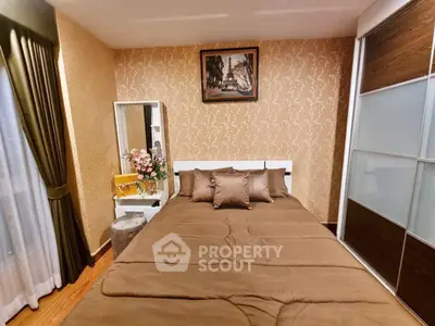 Cozy bedroom with elegant decor and ample natural light, featuring a stylish wardrobe and vanity area.