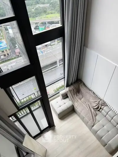 Stunning high-rise living room with floor-to-ceiling windows and city view.