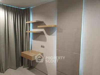 Modern minimalist interior with floating shelves and desk, perfect for a compact study or workspace.