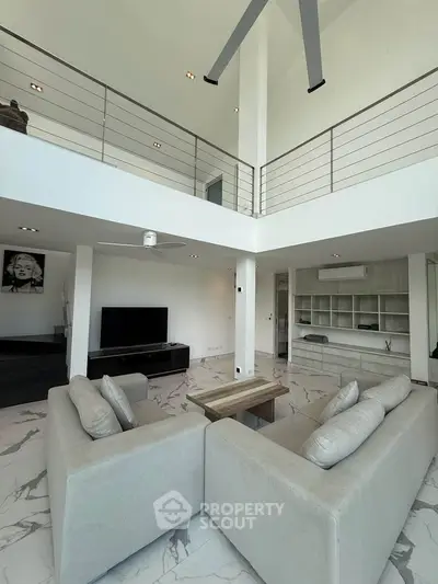 Spacious modern living room with high ceilings and elegant decor