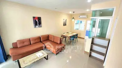Spacious living room with modern furniture and dining area, perfect for family gatherings.