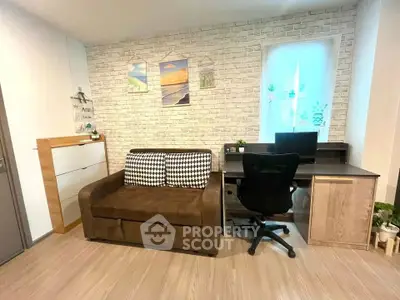 Modern study room with stylish desk and cozy sofa in contemporary apartment.