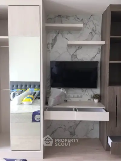 Modern bedroom with stylish built-in wardrobe and wall-mounted TV