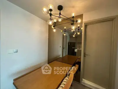 Modern dining area with stylish lighting and wooden table