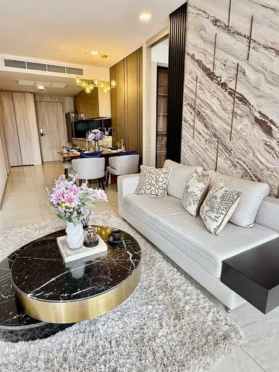 Luxurious modern living room with elegant decor and open layout, featuring a stylish marble coffee table and plush sofa.