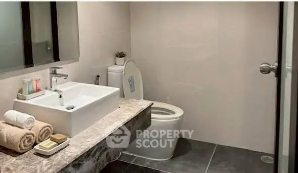 Modern bathroom with sleek fixtures and elegant marble countertop.