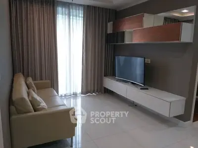 Modern living room with sleek TV setup and elegant curtains