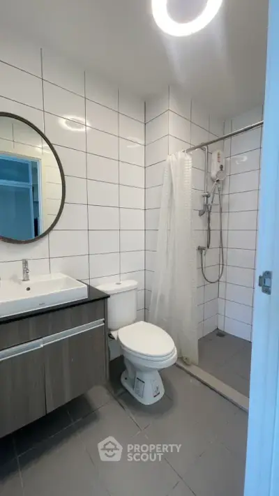 Modern bathroom with sleek fixtures and a spacious shower area.