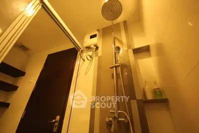 Modern bathroom with sleek shower and warm lighting, perfect for relaxation.