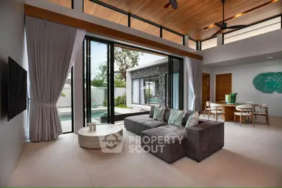 Luxurious modern living room with pool view, high ceilings, and elegant decor.