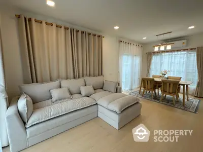 Spacious living room with elegant dining area and cozy sectional sofa